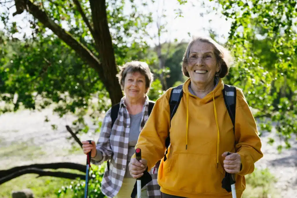 Deux femmes senior randonnent dans la forêt.
